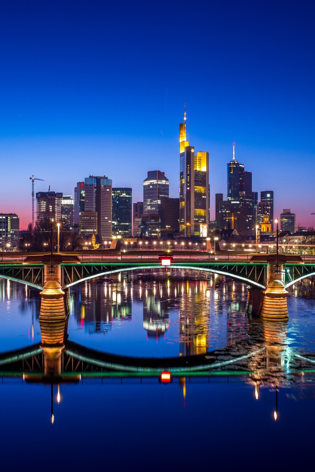 The night city of Frankfurt is reflected in the water, Germany