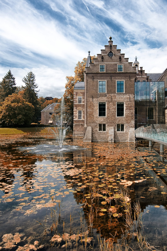 Castle Huis te Ruurlo near the water under the beautiful sky, Netherlands