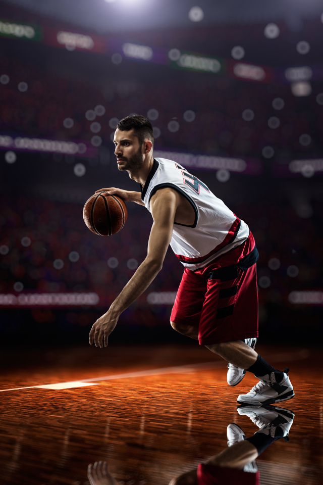 Basketball player with a ball playing on the field