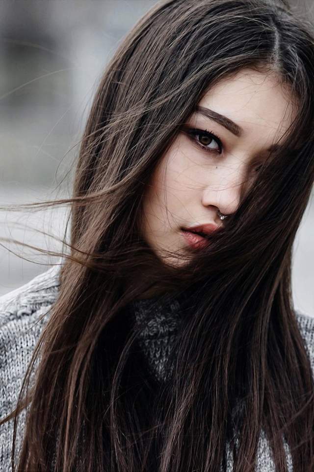 Brunette asian girl with piercing in the nose
