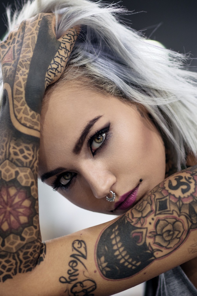 Молодая девушка с татуировками на теле 