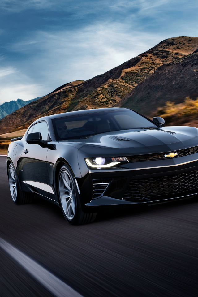 Черный быстрый автомобиль Chevrolet Camaro SS, 2018 года на трассе у гор