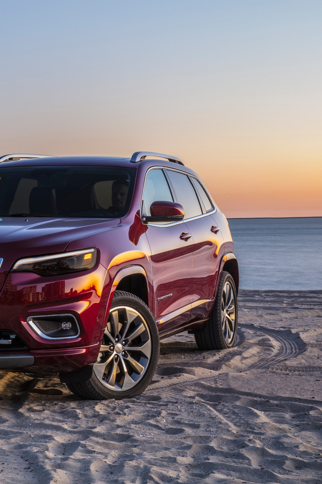 Бордовый внедорожник Jeep Cherokee Overland, 2018 на пляже
