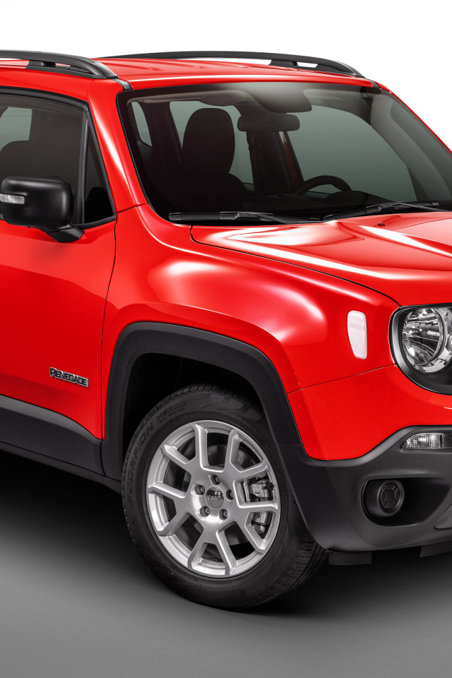Красный автомобиль Jeep Renegade Sport на сером фоне