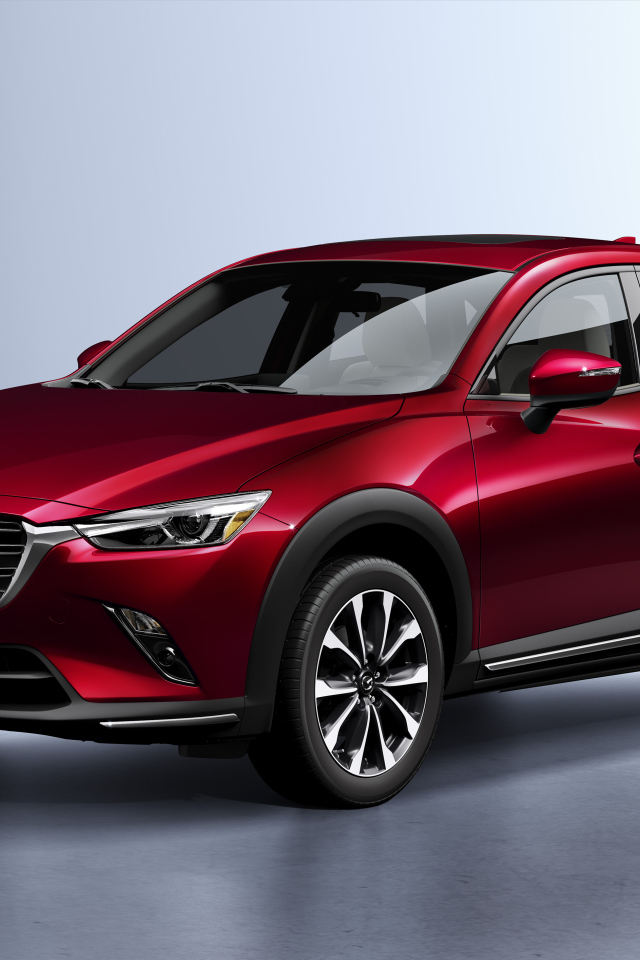Бордовый внедорожник Mazda CX-3, 2019 года на сером фоне