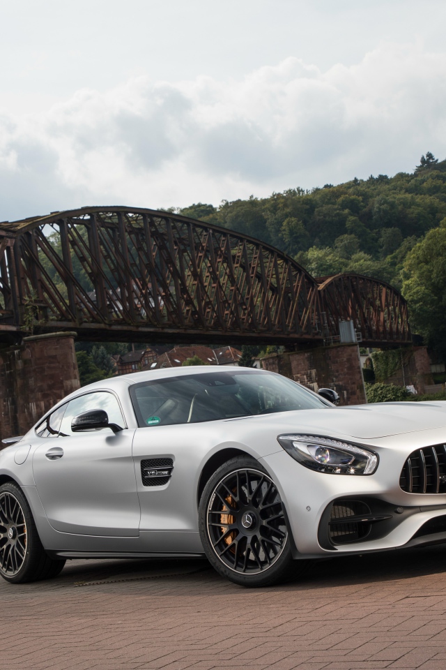 Silver car Mercedes-AMG GT on the background of the bridge