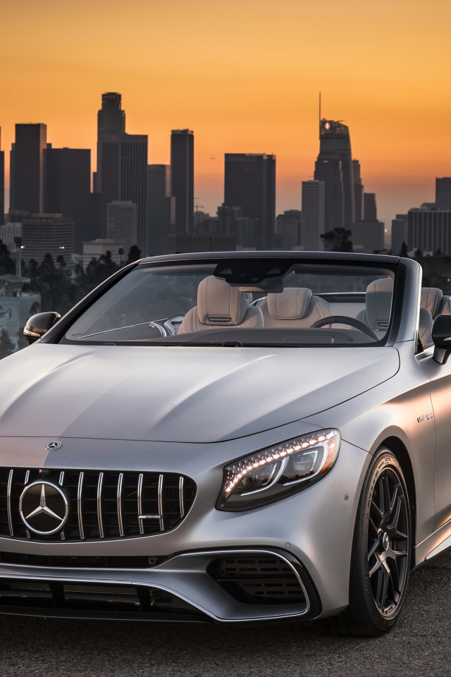 Silver car Mercedes AMG S63 4MATIC Cabriolet, 2018 on the background of a metropolis