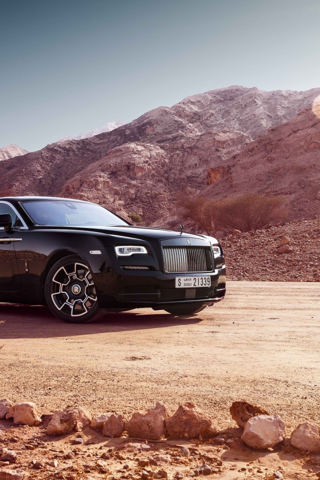 Stylish car Rolls Royce Wraith Black Badge on the background of the mountains