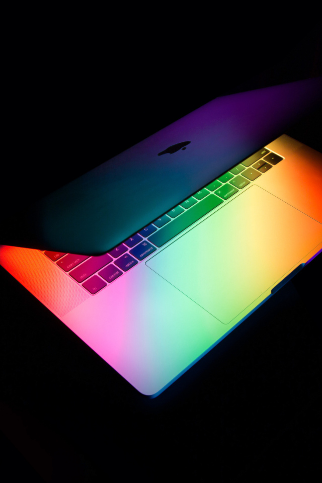 Открытый MacBook Apple  на черном фоне