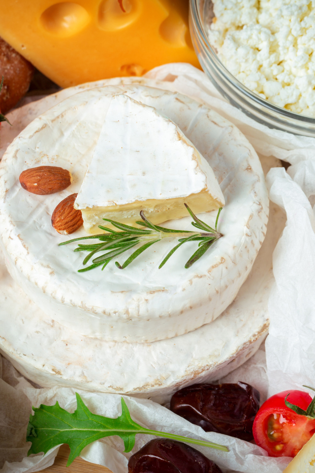 Разные виды сыра на столе с помидорами 