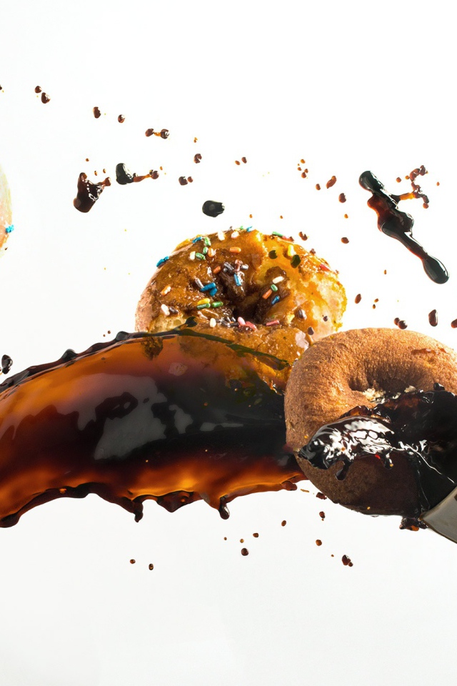 Пончики с чашкой кофе на белом фоне