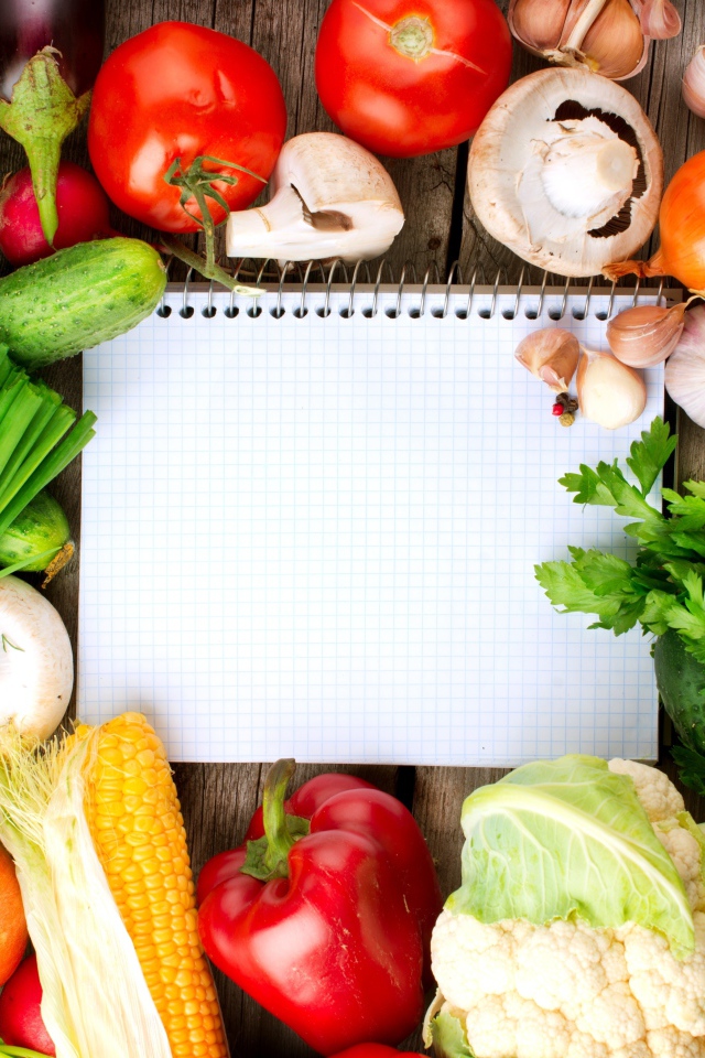 Notebook with fresh vegetables on the table