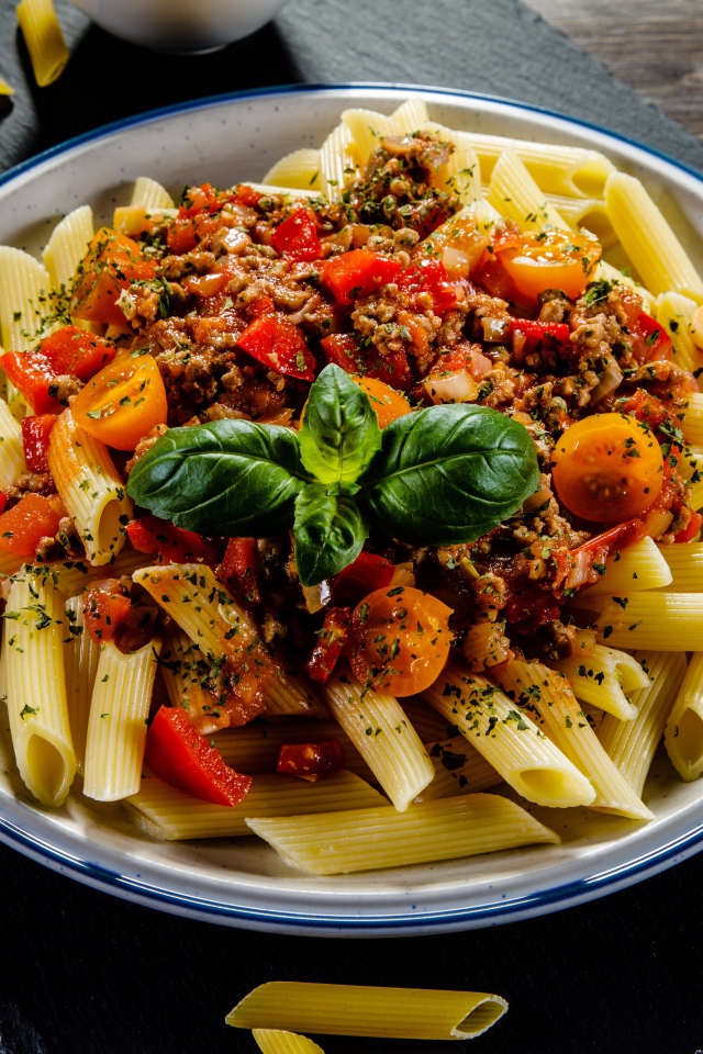 Pasta with minced meat and tomatoes on the table
