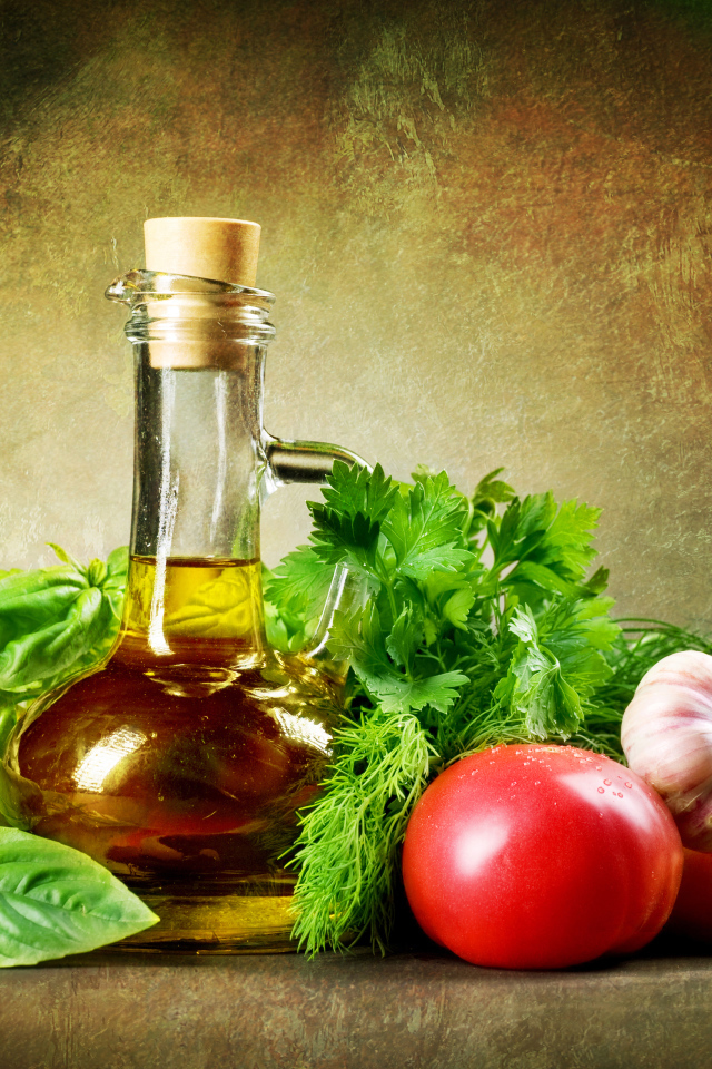 Овощи на столе с  кувшином растительного масла