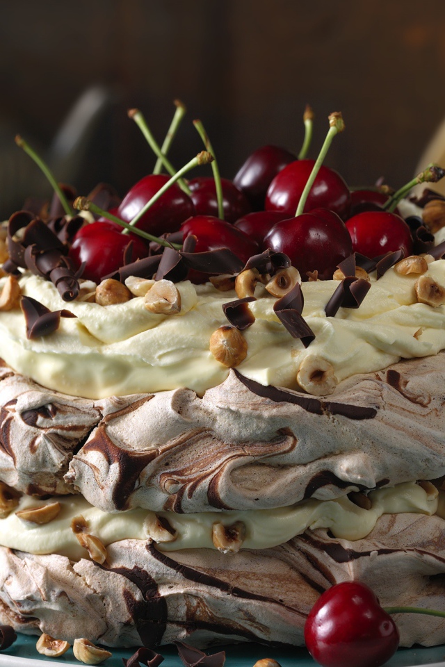 Красивый кремовый торт с шоколадом и ягодами черешни и орехами