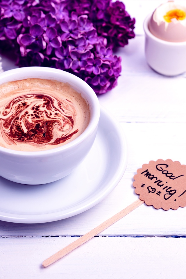 Белая чашка кофе с цветами сирени и яйцом на завтрак
