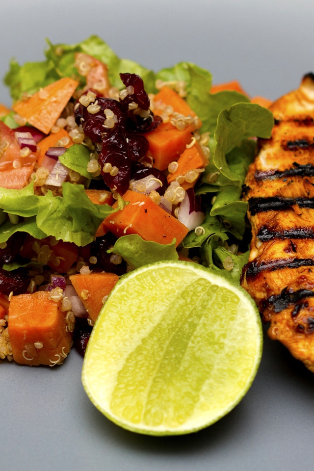 Мясо барбекю с овощами и лаймом на серой тарелке 