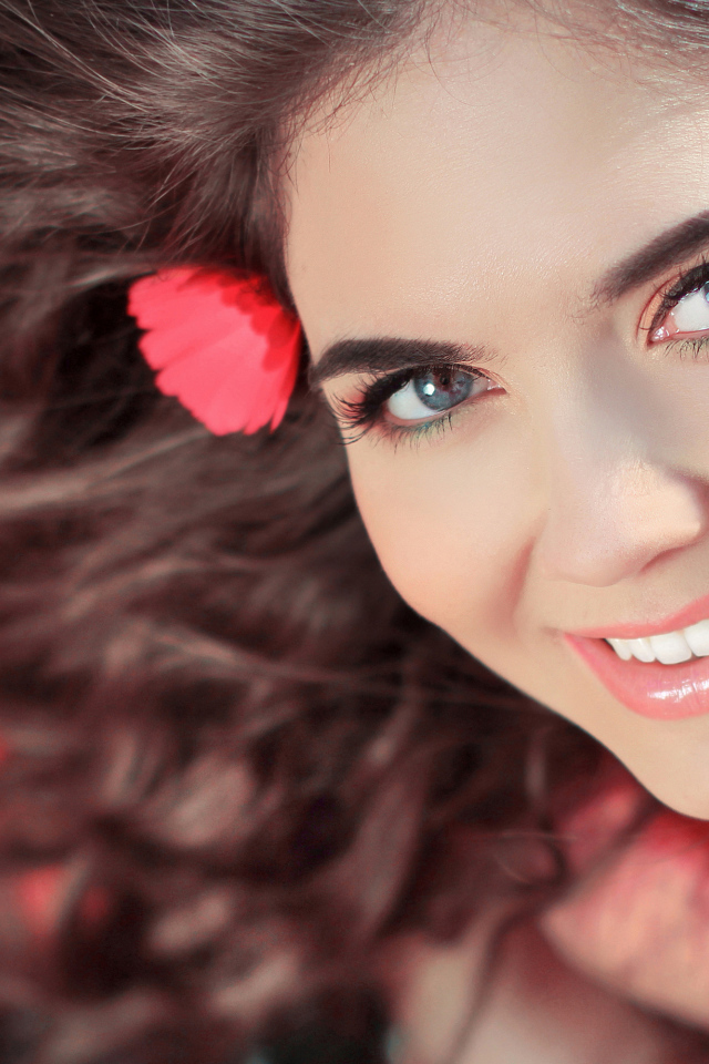 Красивая улыбающаяся девушка с цветами в волосах 