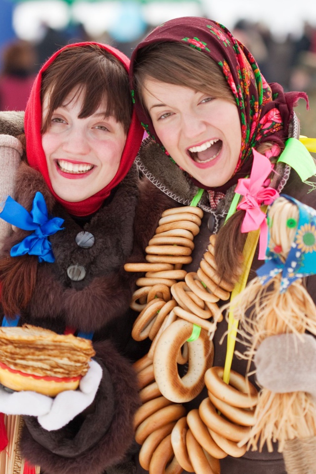 Две девушки с блинами и баранками на Масленицу