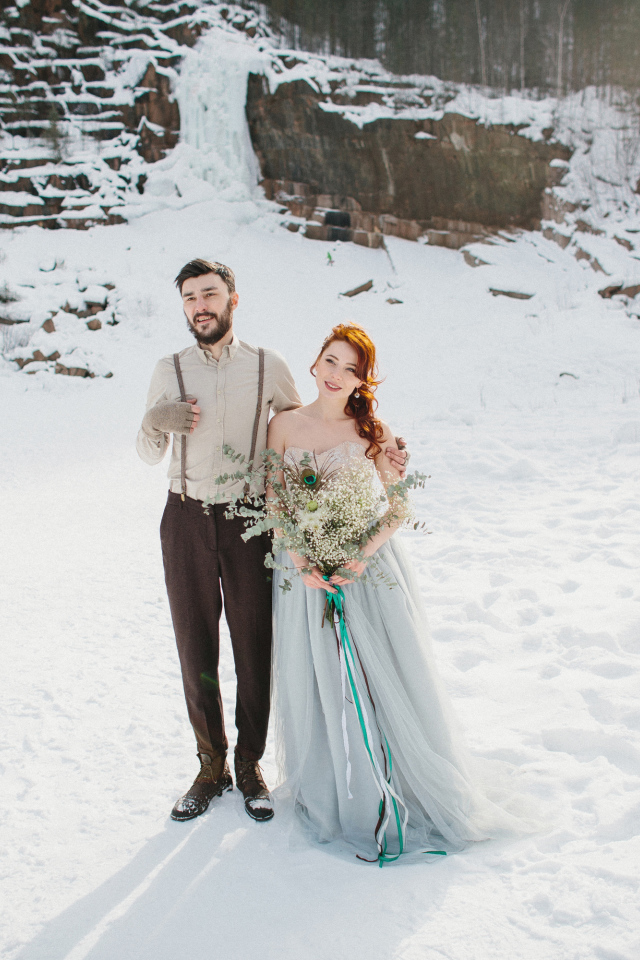 Влюбленная пара молодоженов стоит на снегу
