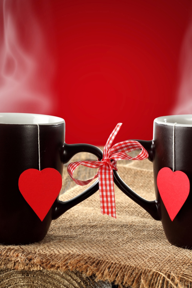 Two cups of hot tea tied with a bow