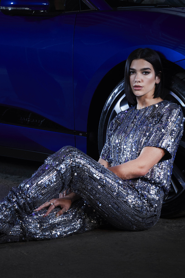 Певица Дуа Липа в блестящем костюме у машины
