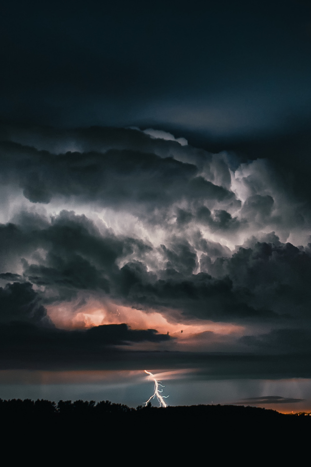 Stormy clouds with lightning in the evening sky