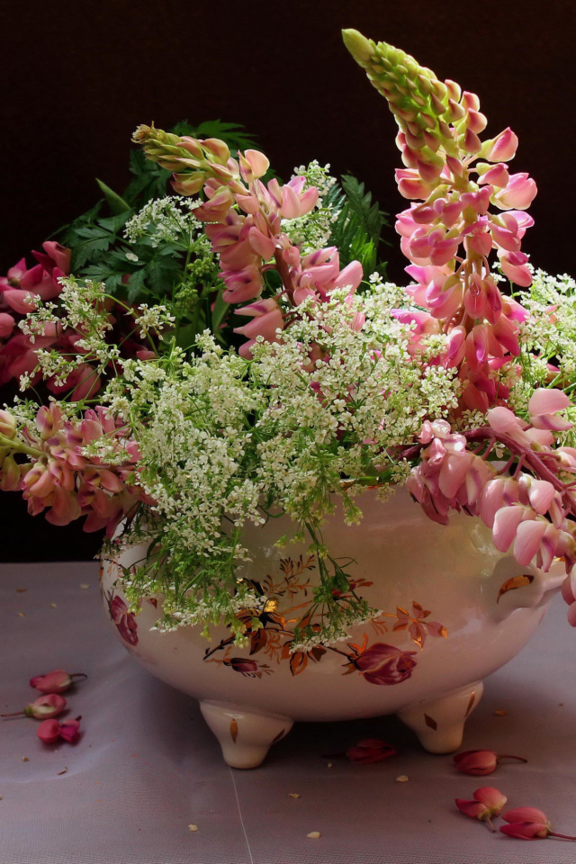 Розовые цветы люпина с полевыми цветами в вазе