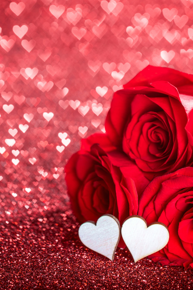 Три красные розы с маленькими белыми сердечками на красном фоне