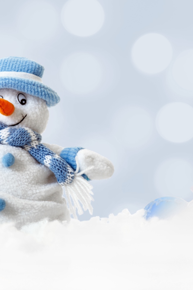 Игрушка снеговик и елочная игрушка на снегу 