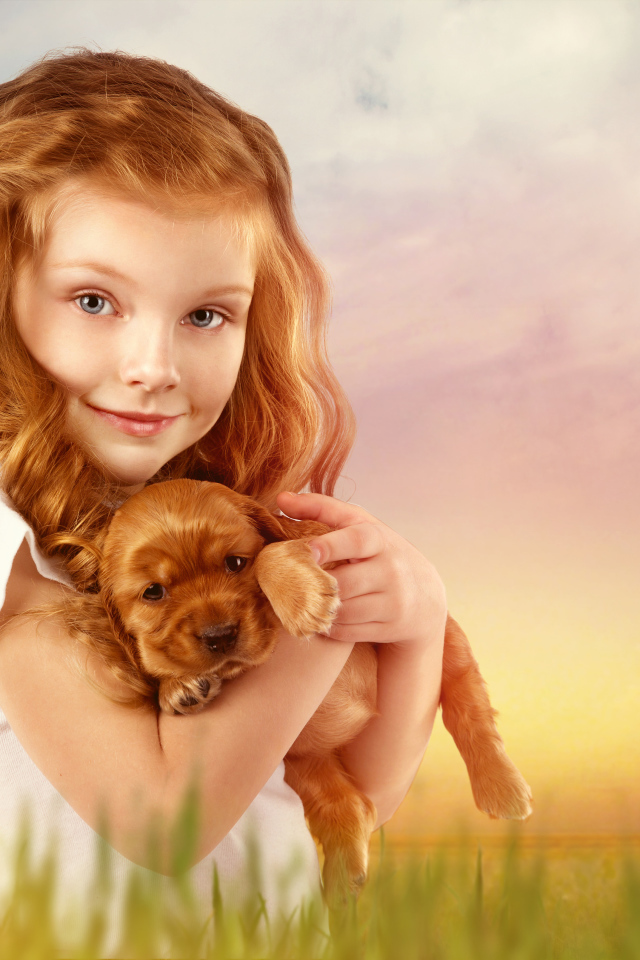 Beautiful red-haired girl with a puppy