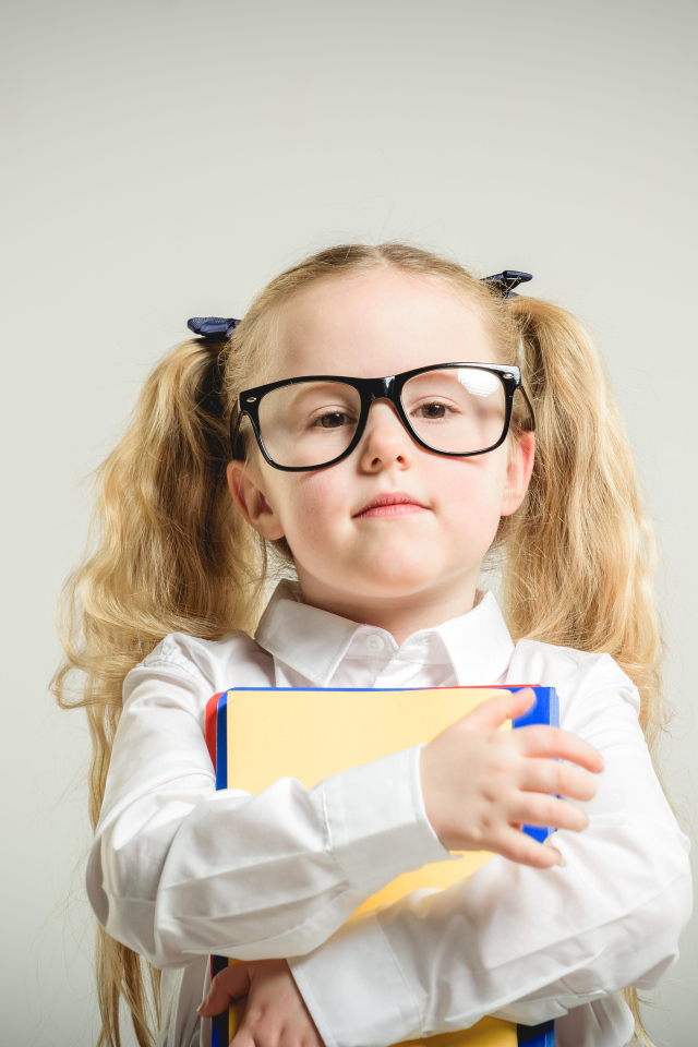 Девочка школьница в очках с книгами