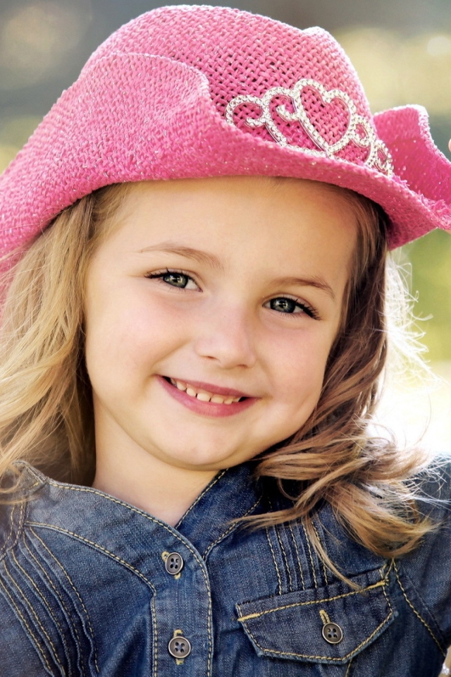 Улыбающаяся девочка в розовой шляпе