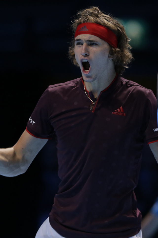Professional tennis player Alexander Zverev with a racket screams on the court
