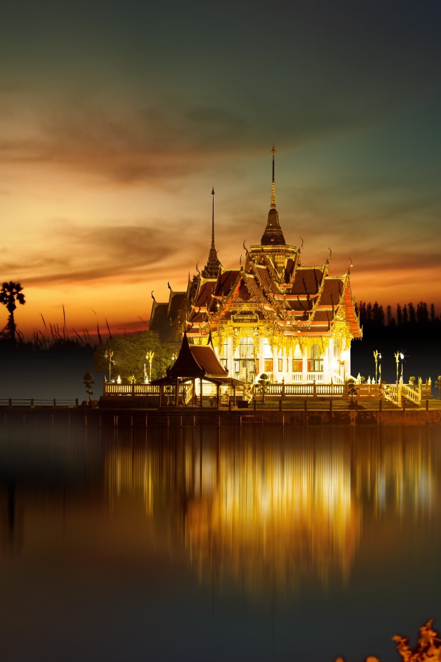 Buddhist temple by the water at night, Asia