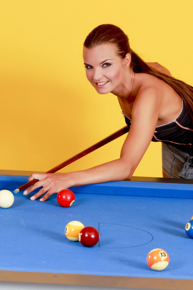 Young girl playing pool