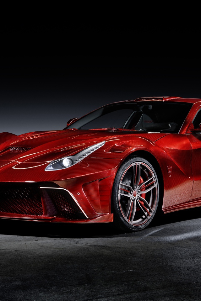 Красный автомобиль Mansory La Revoluzione на сером фоне