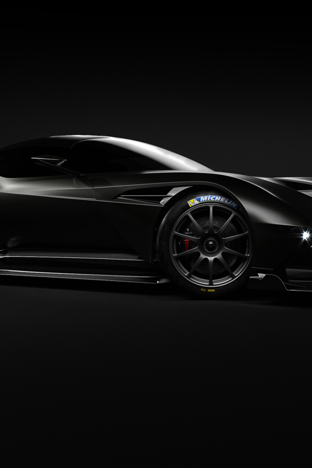 Черный спортивный автомобиль Aston Martin Vulcan на сером фоне