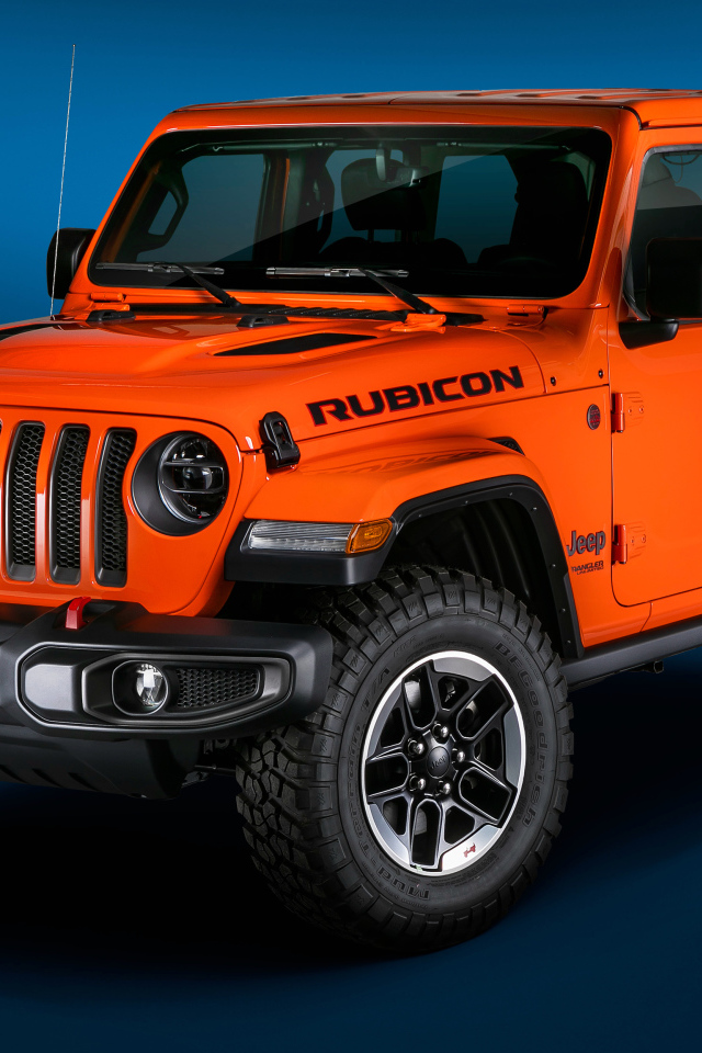Оранжевый Jeep Wrangler Unlimited Rubicon 2018 года на синем фоне