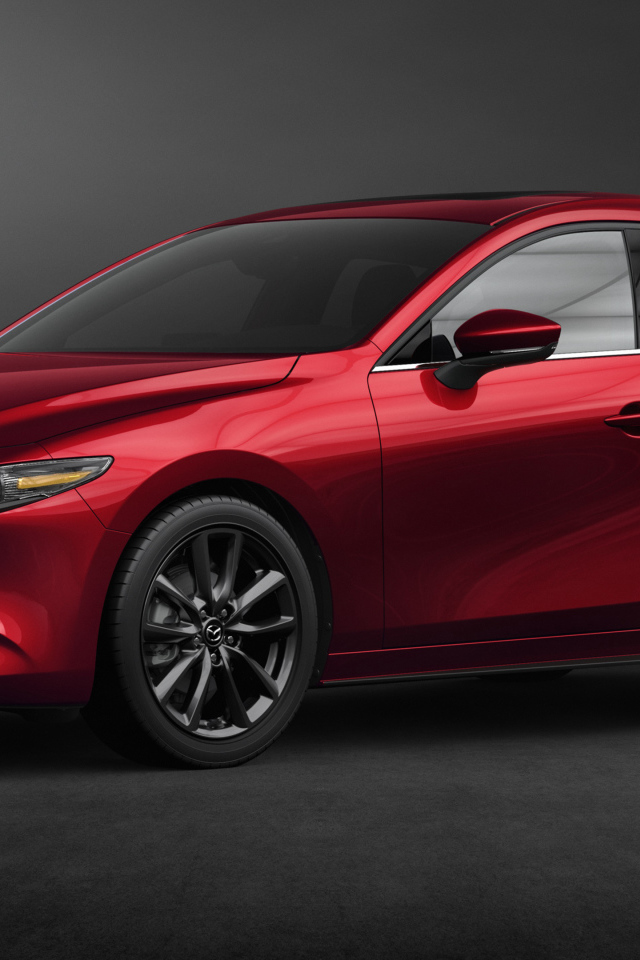 Красный автомобиль Mazda 3, 2020 года на сером фоне
