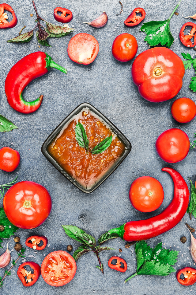 Соус на  сером фоне с овощами, специями и зеленью