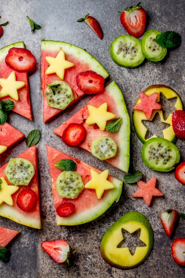 Кусочки арбуза с фруктами на сером фоне