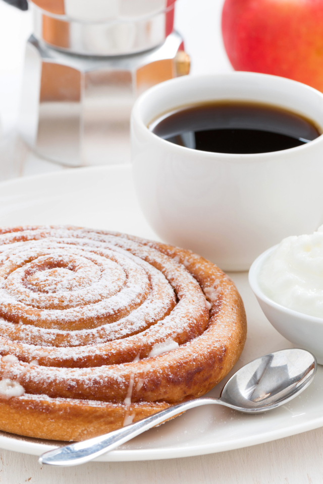 Чашка кофе на тарелке с выпечкой и сливками