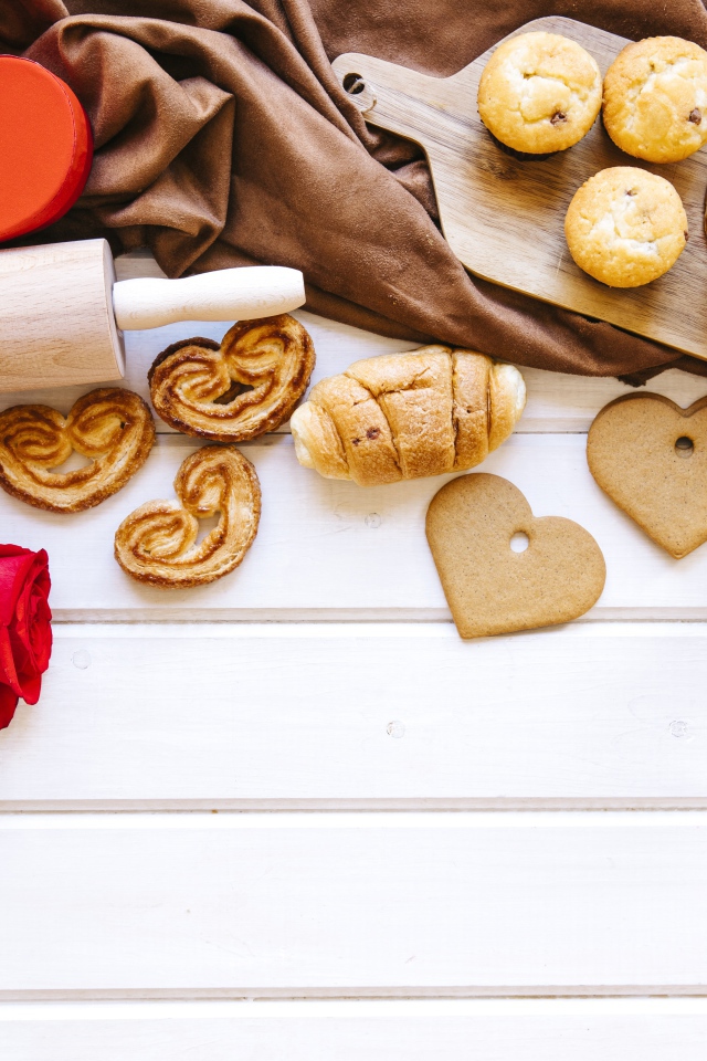 Аппетитная сладкая выпечка на столе с кофе, сердечками и подарками 