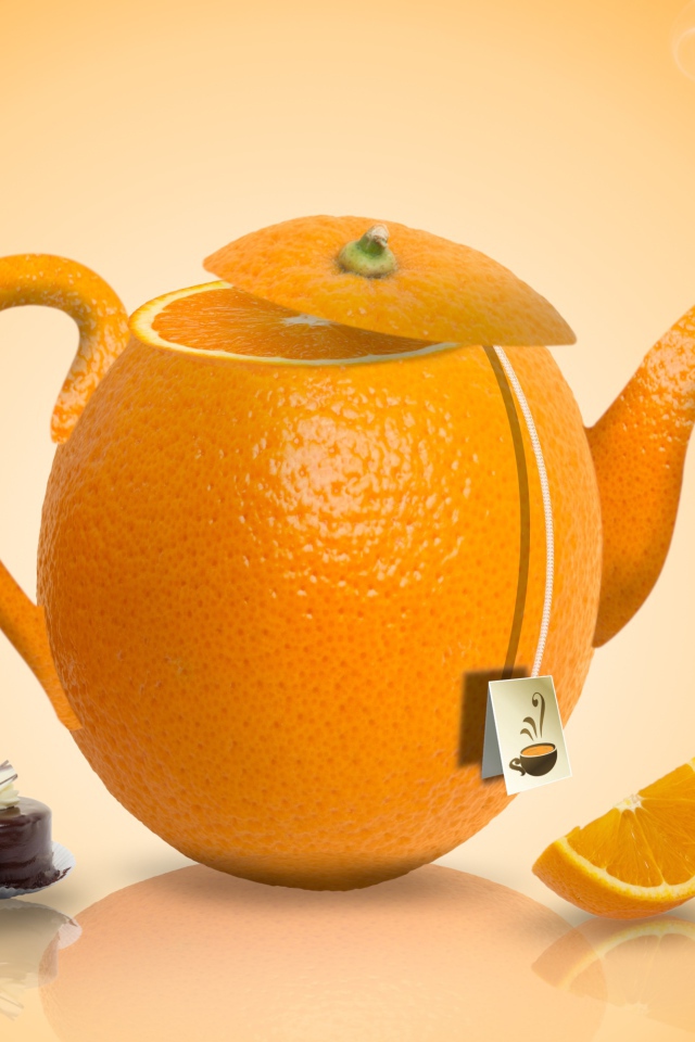 Чайник апельсин на оранжевом фоне с конфетами