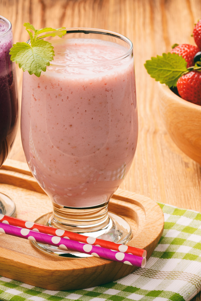 Два стакана смузи на столе с ягодами