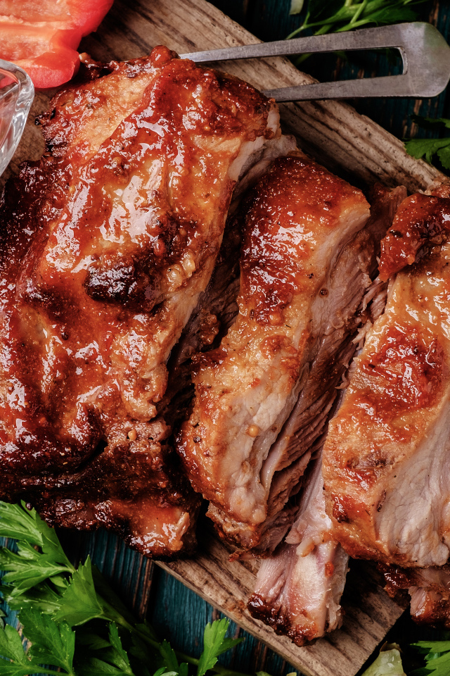 Сочный кусок запеченного мяса на столе с соусом