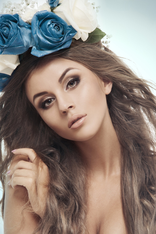 Красивая девушка с венком на голове на сером фоне