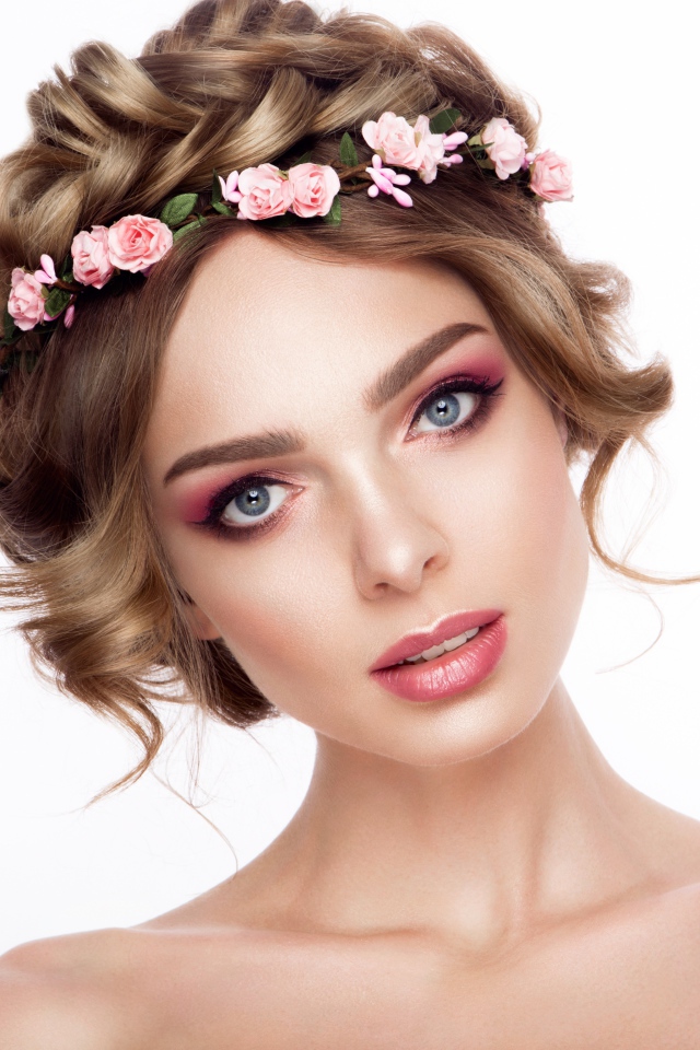 Красивая нежная голубоглазая девушка с венком на голове на белом фоне