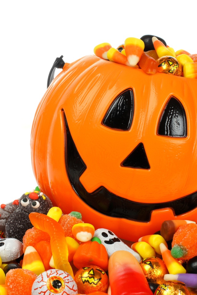 Тыква со сладостями на белом фоне